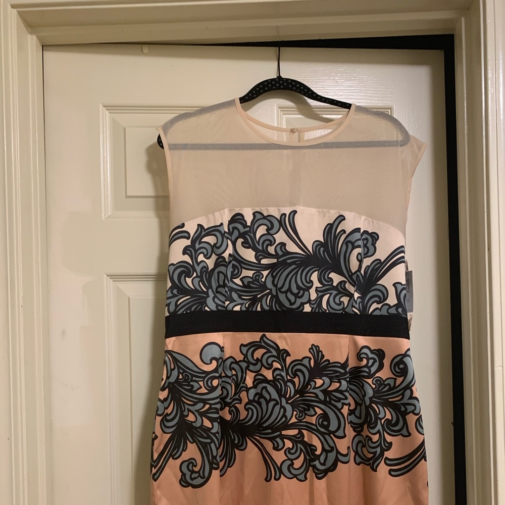 Light peach colored short dress with black details